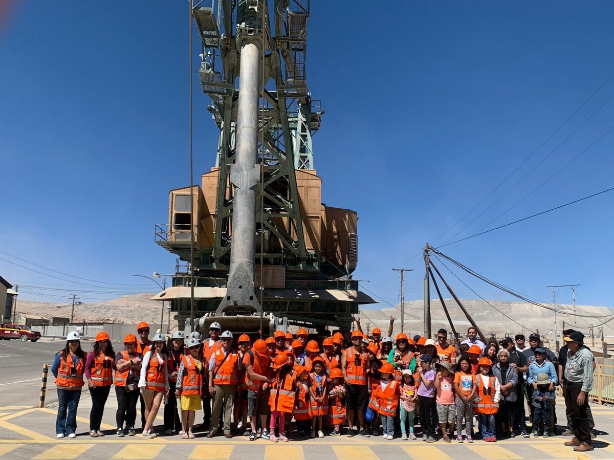Visiting group in hard hats at an industrial site in northern Chile